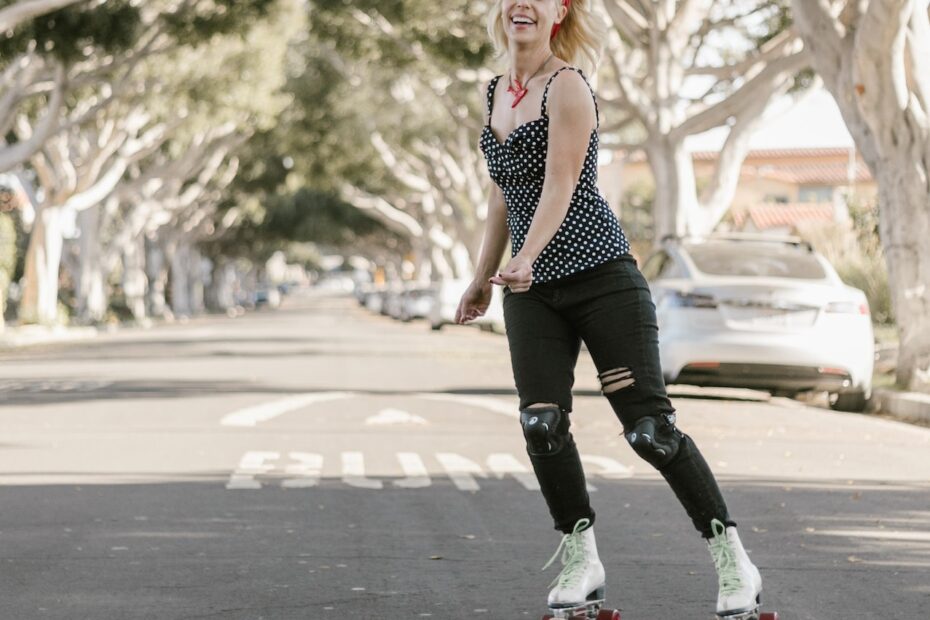 cheerful-woman-rollerskating-down-an-outdoor-street-in-warm-weather-on-affordable-retro-roller-skates