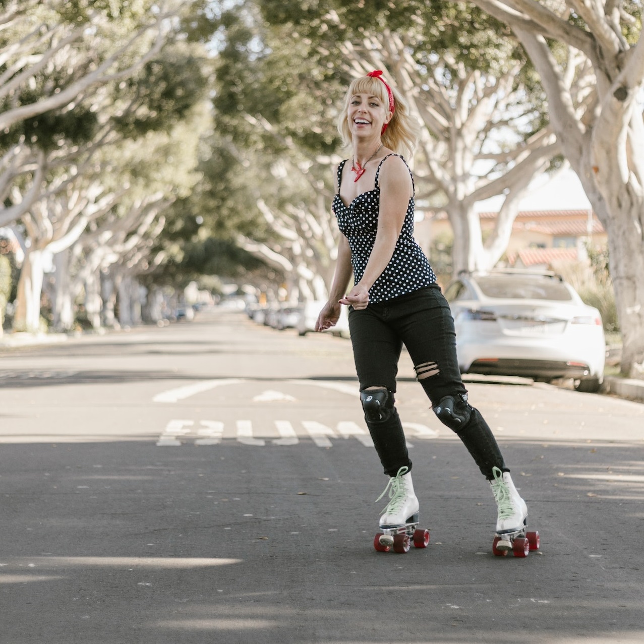cheerful-woman-rollerskating-down-an-outdoor-street-in-warm-weather-on-affordable-retro-roller-skates